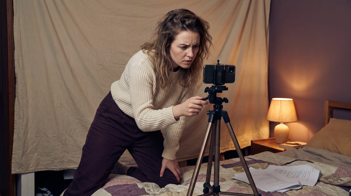 An actor adjusting her phone tripod mid-take instead of playing the scene