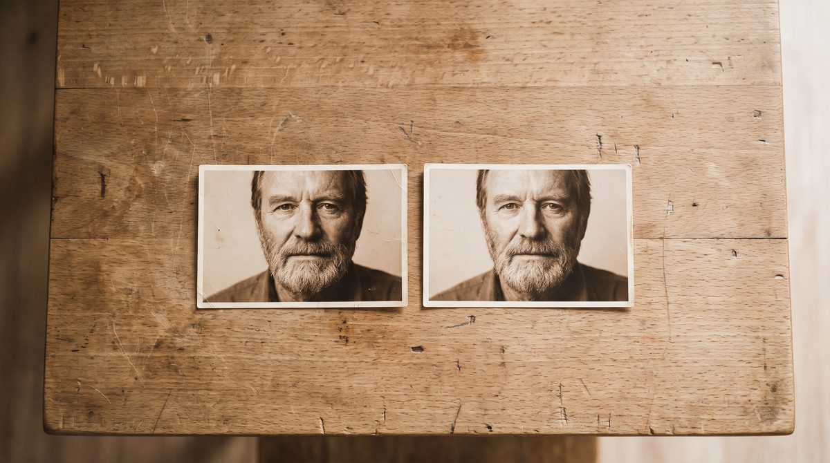 Two printed photographs of the same person laid side by side on a table