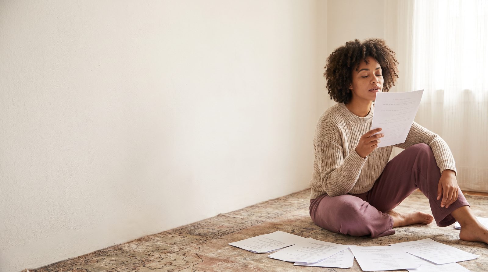 An actor working a line from memory with script pages beside her