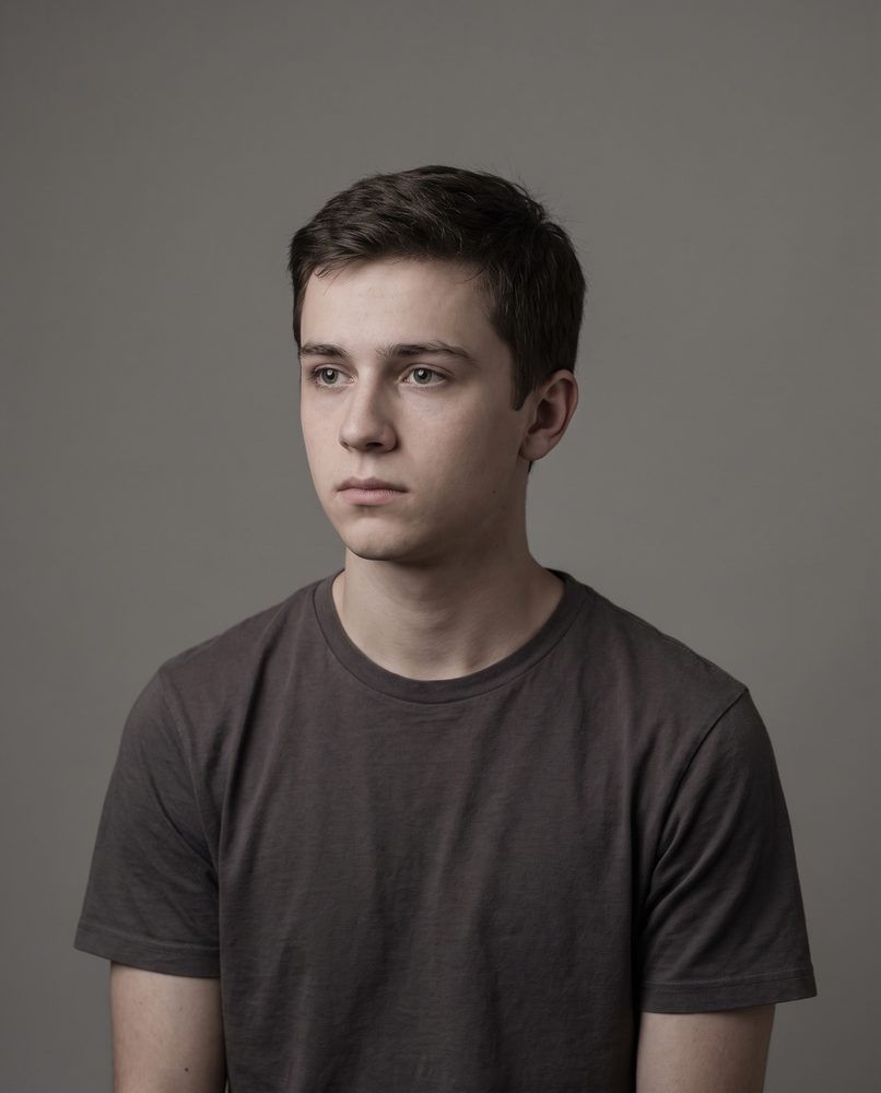A young actor listening to an off-camera reader in a self-tape frame
