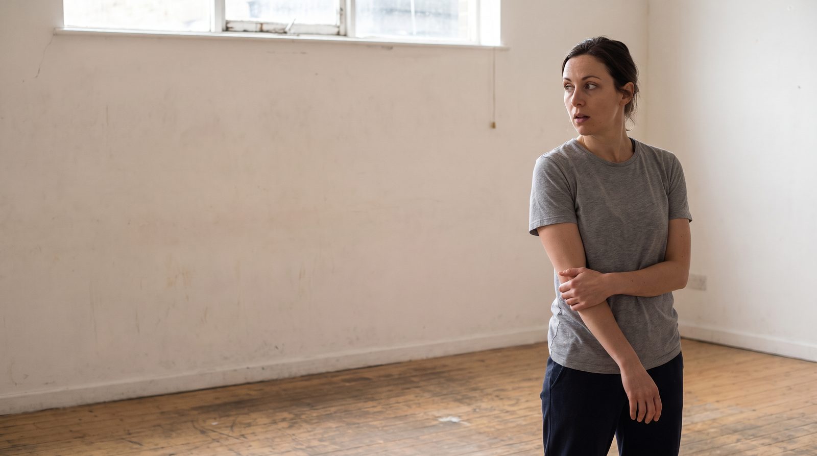 An actor mid-scene with her whole attention on an unseen scene partner