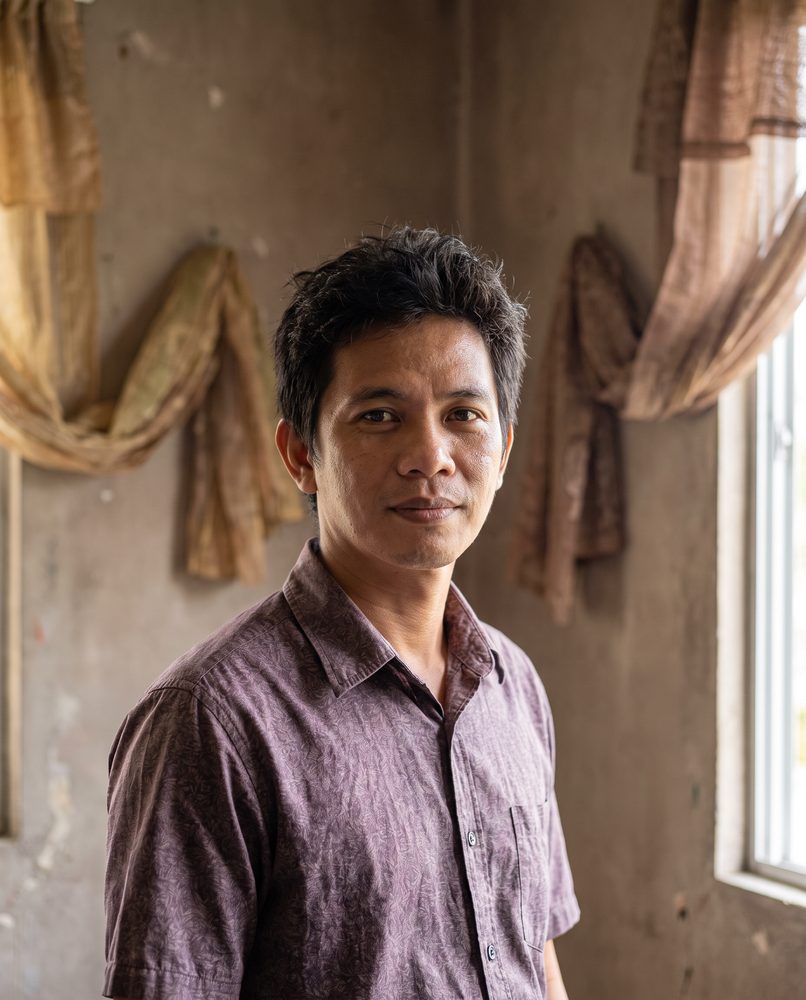 An actor standing in a soft-furnished room, ready to record with good sound